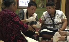 Dr Patrick Indradjaja with Elis' family in Cigondang village, Indonesia