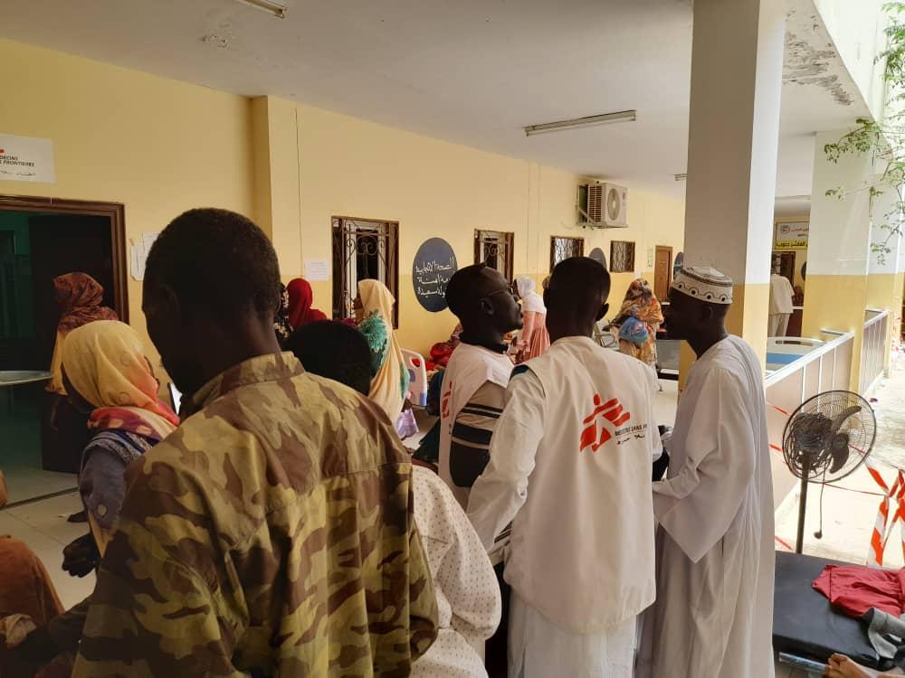People gather at a health facility in El Fasher